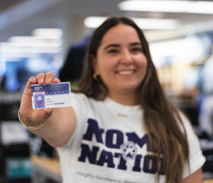 Student holding an ID card 