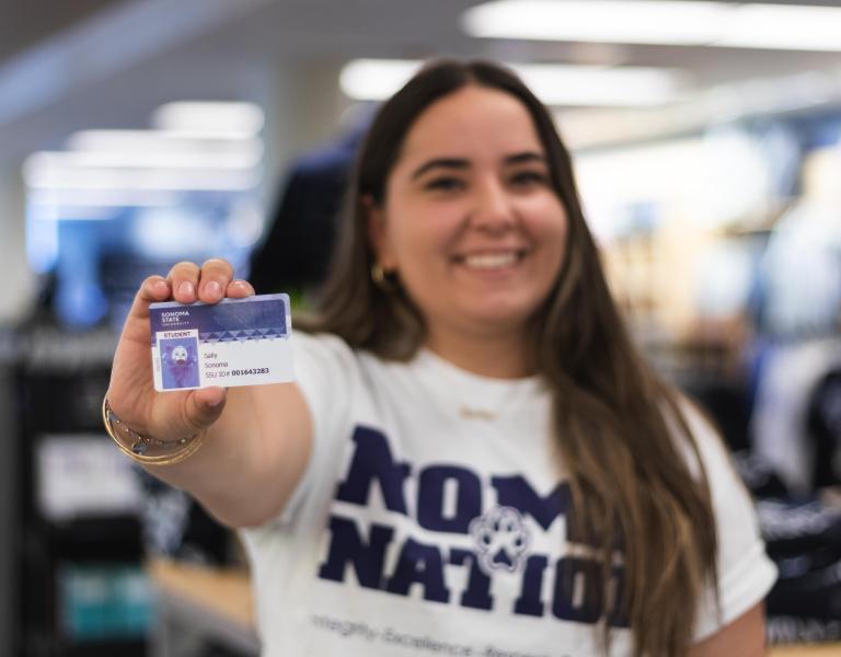 Student holding an ID card 